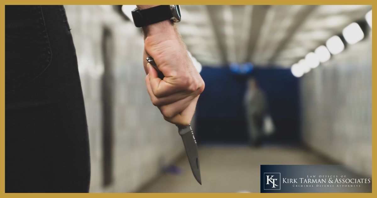 Man holding a knife in a tunnel