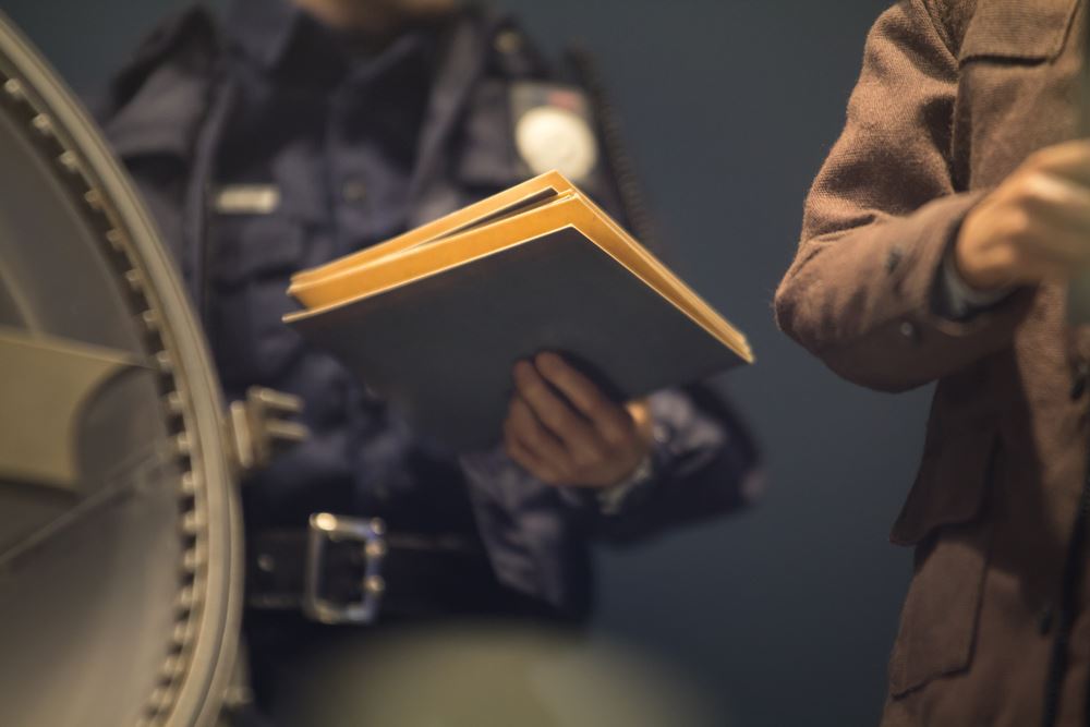 Policeman is reviewing files and documents